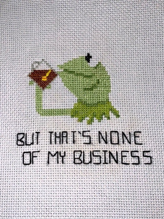Cross-stitch of Kermit the frog and text that says, &quot;But that&#x27;s none of my business&quot;