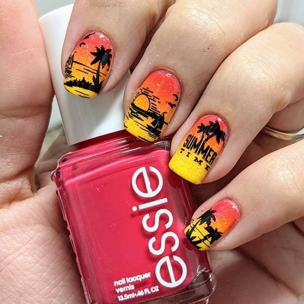 Five nails curled into a bottle of Essie nail polish. The nails have tropical designs on them, with the ring finger sporting a design that says, &quot;Summer time&quot;