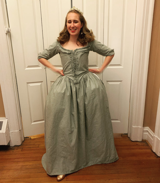 Woman posing with a voluptuous medieval-style dress that balloons at her hips