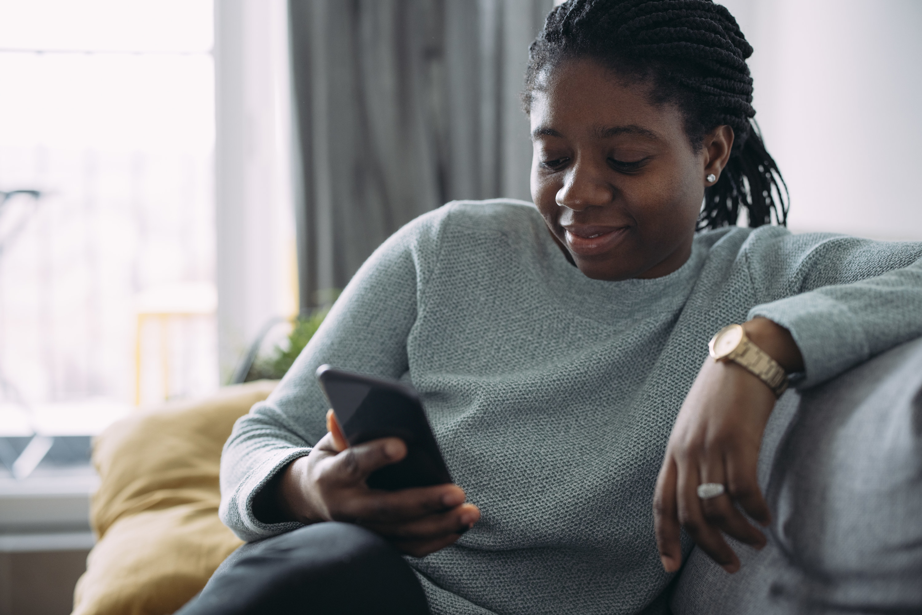 Woman smiles with using an app on her phone