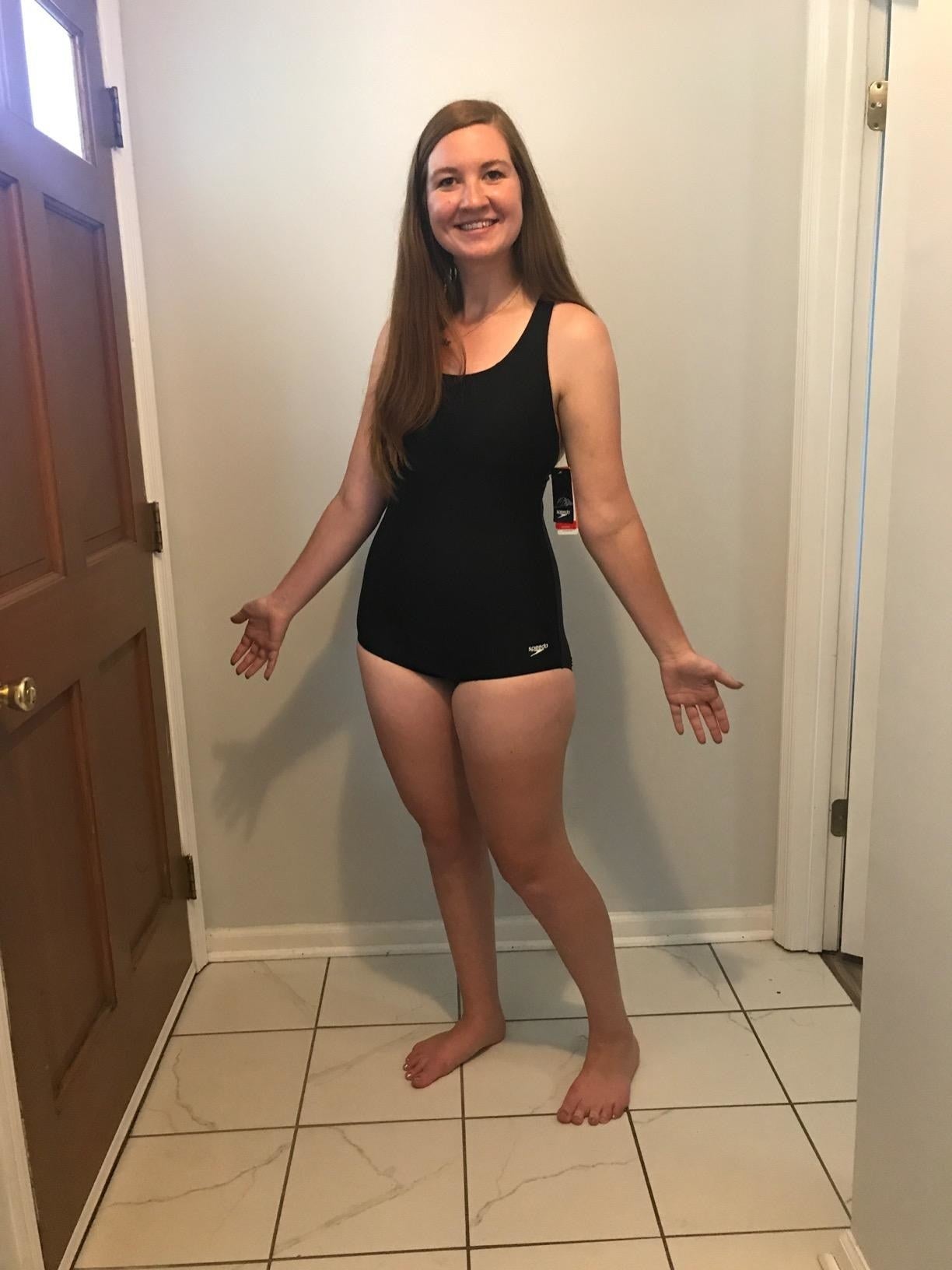 a reviewer in a one-piece swimsuit