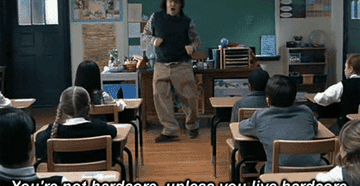 Jack Black in School of Rock dancing at the front of a classroom