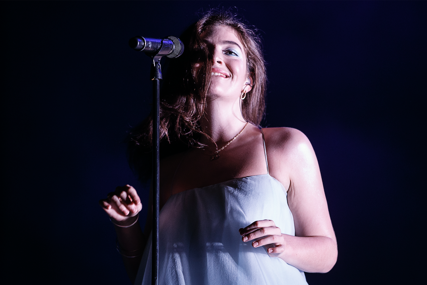 Lorde, wearing spaghetti straps, smiles and stands at the microphone during Day Four of the Primavera Sound Festival in Barcelona, Spain, in 2018