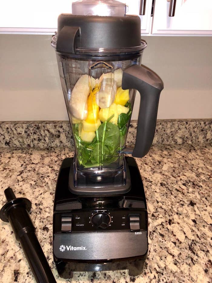 a reviewer photo of the blender filled with fruit