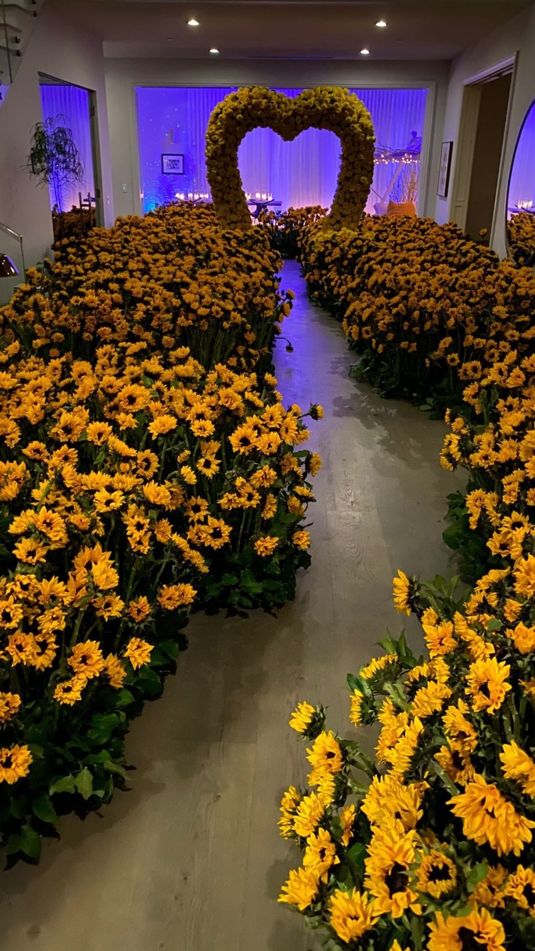 An elaborate sunflower path that leads to a large heart-shaped alter made out of flowers