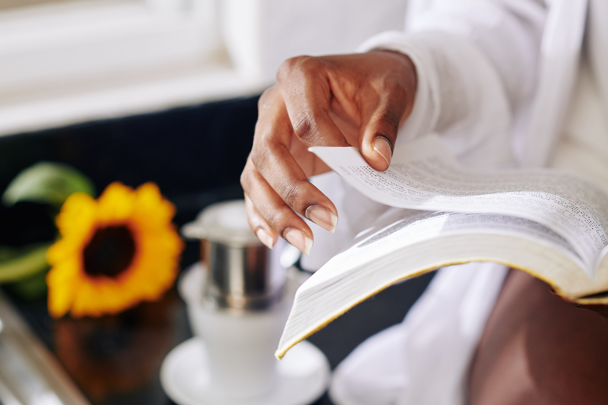 A woman turning the pages of a book