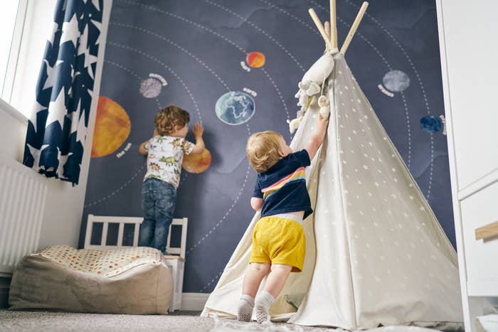 Kids playing in their room with a tent