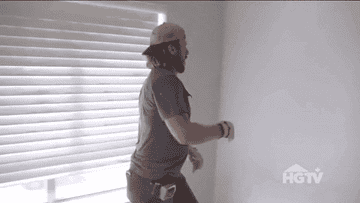 Chip Gaines smashing a wall