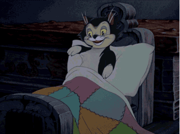 gif of cat from disney&#x27;s pinnochio snuggling into bed