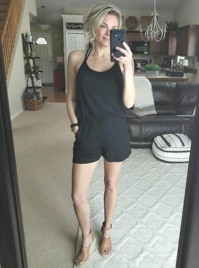 A reviewer wearing a women&#x27;s spaghetti strapped romper in black