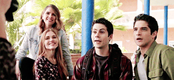 three teen wolf characters smile