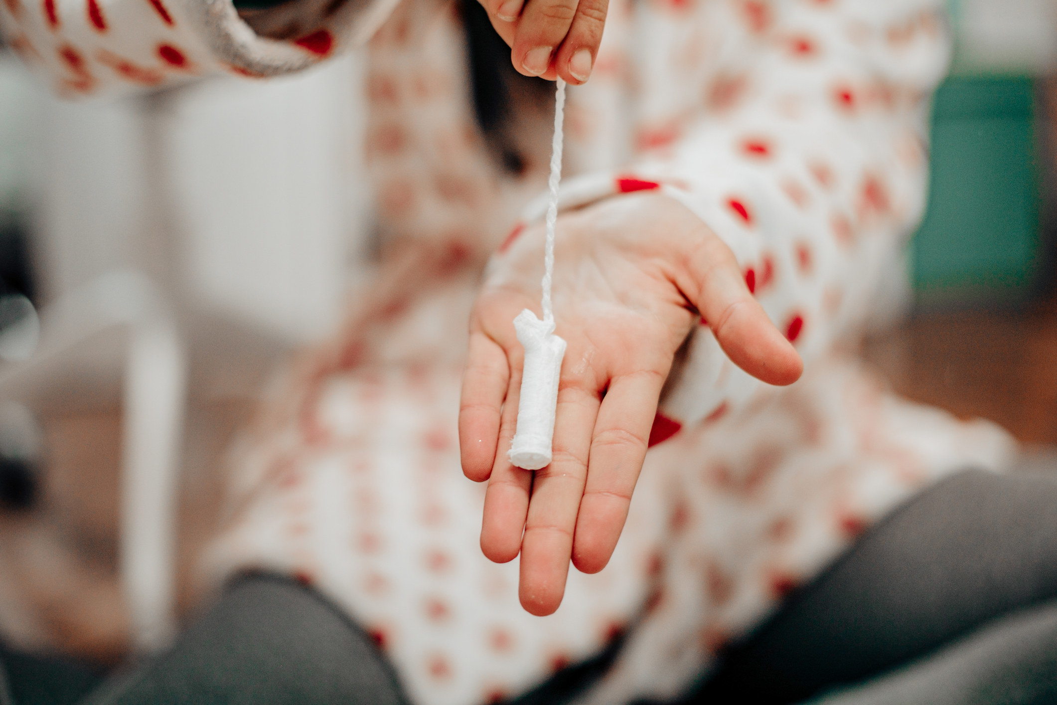 a woman holding a tampon