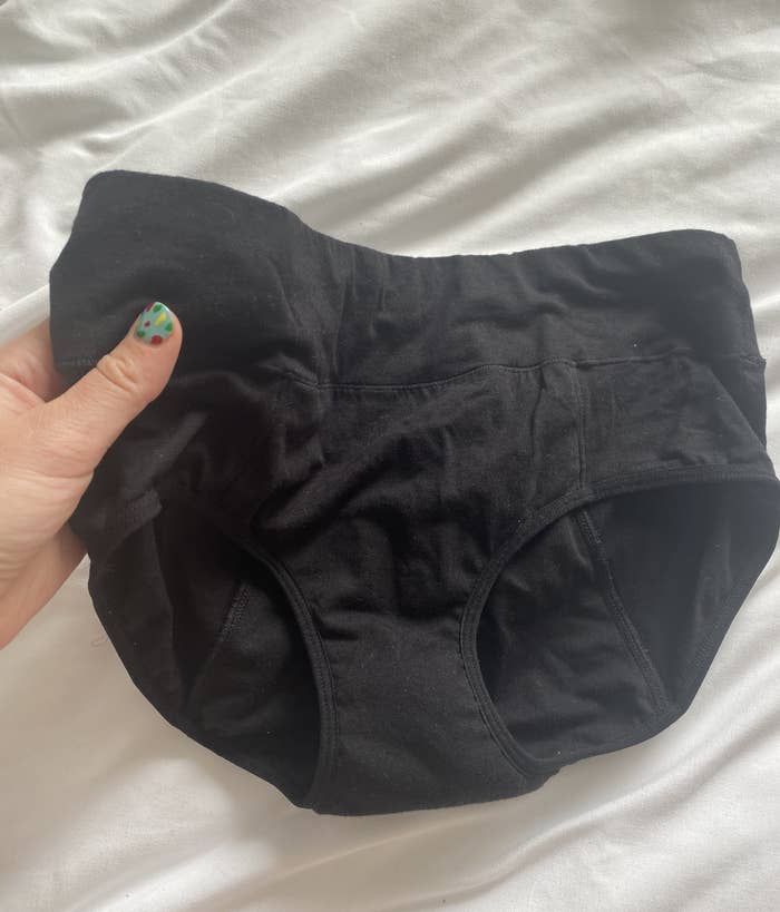 BuzzFeed editor holding pair of black underpants