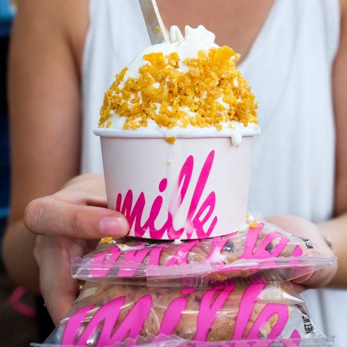 white ice cream with cornflakes over a stack of wrapped cookies