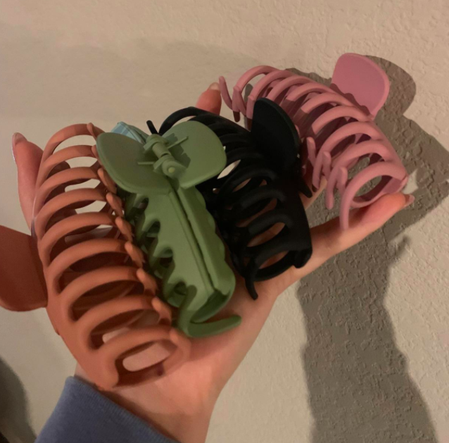 A customer review photo of them holding four of the clips