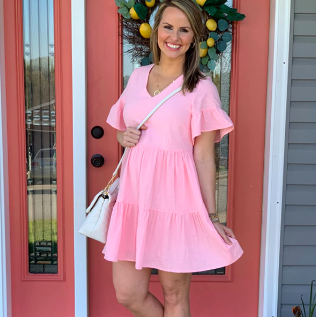 A customer review photo of them wearing the dress in pink