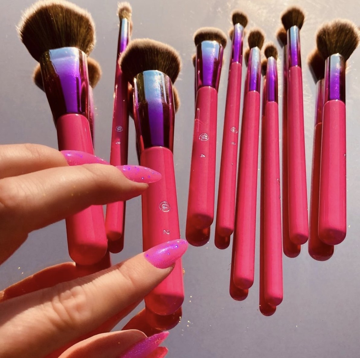 A set of pink handled makeup brushes