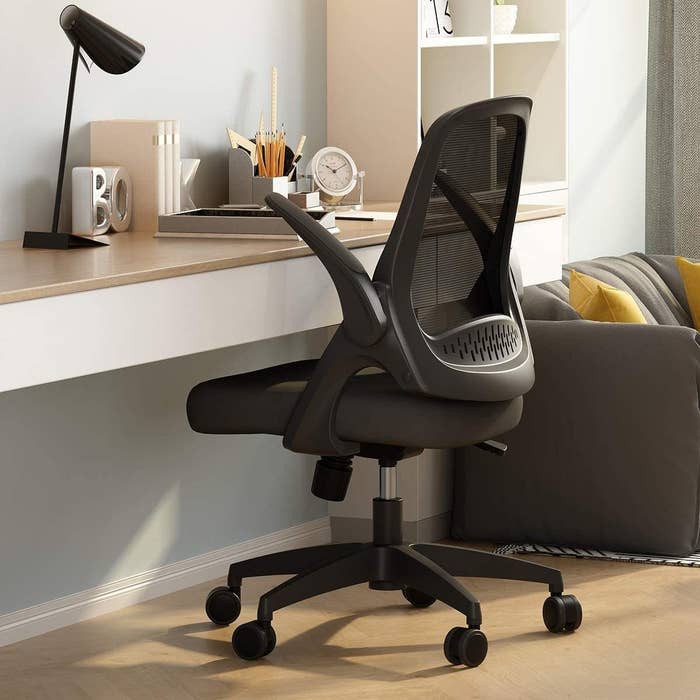 desk chair pulled up next to desk with arms adjusted for appropriate height