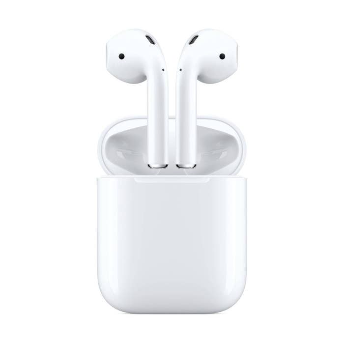 white Apple AirPods inside charging case