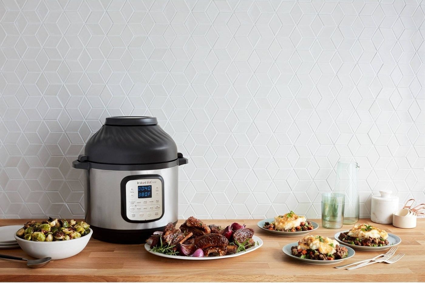 instant pot and air fryer combo on a table with foods nearby