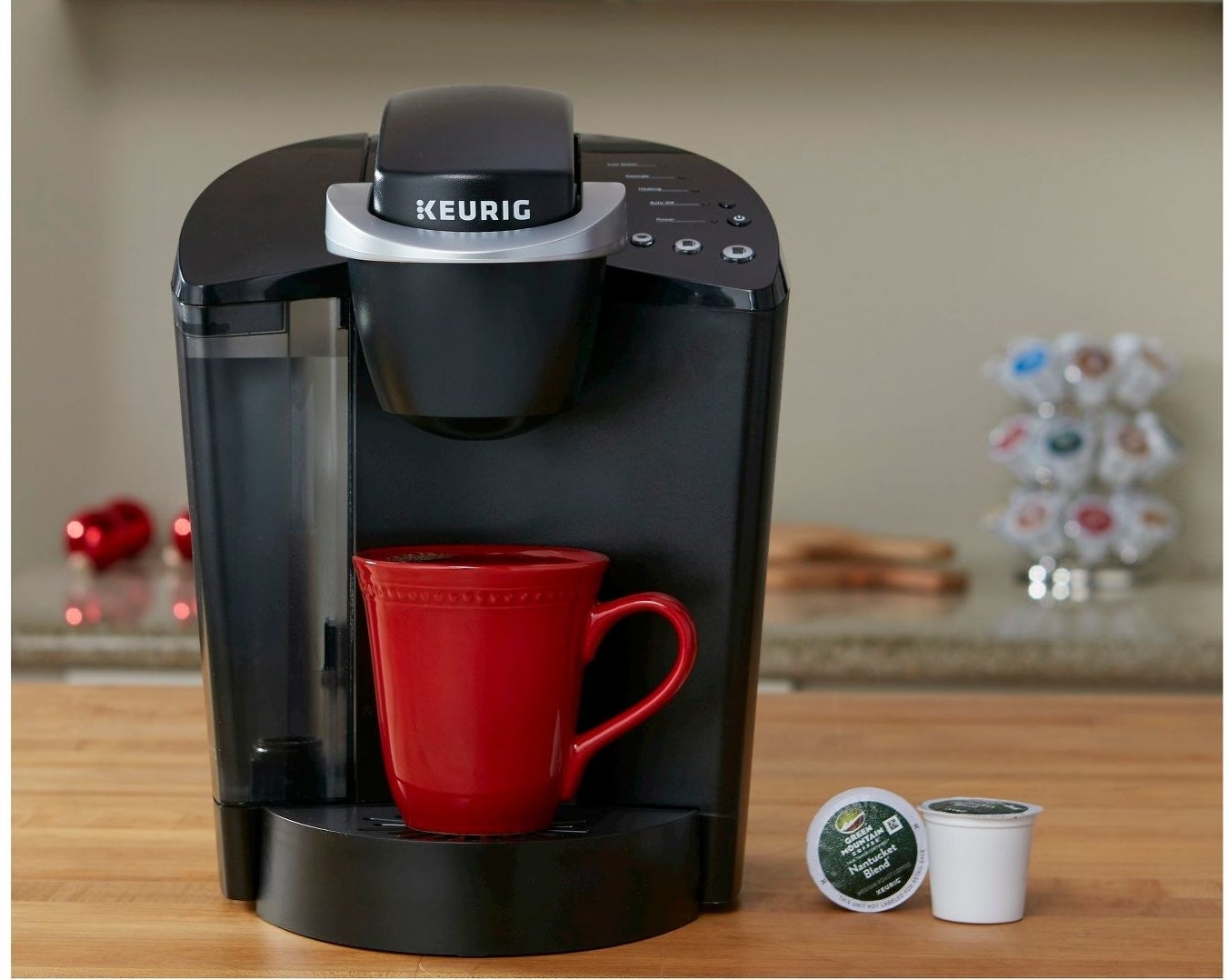 keurig coffee maker with red mug of coffee on a counter