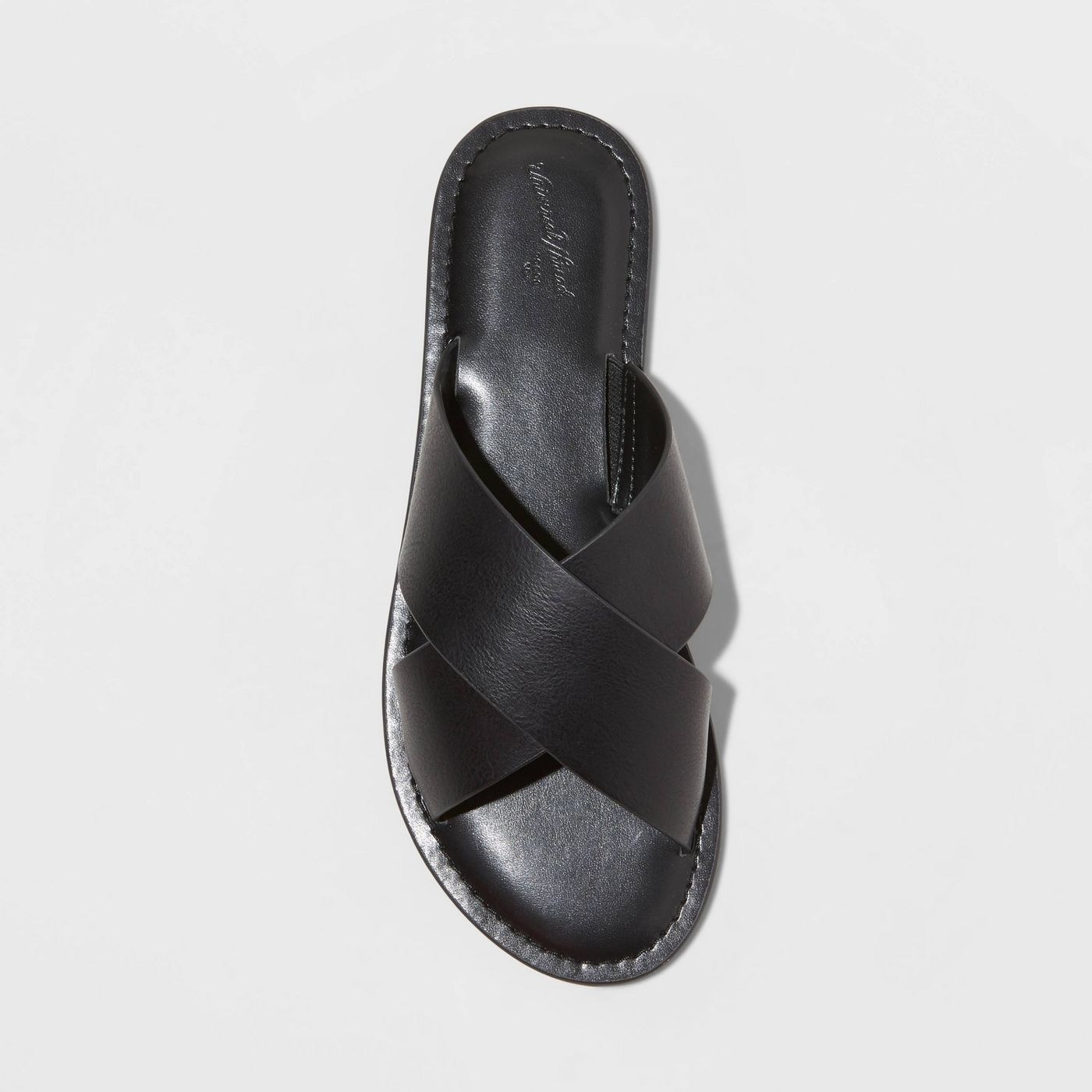 A black faux leather slide sandal with crossband straps