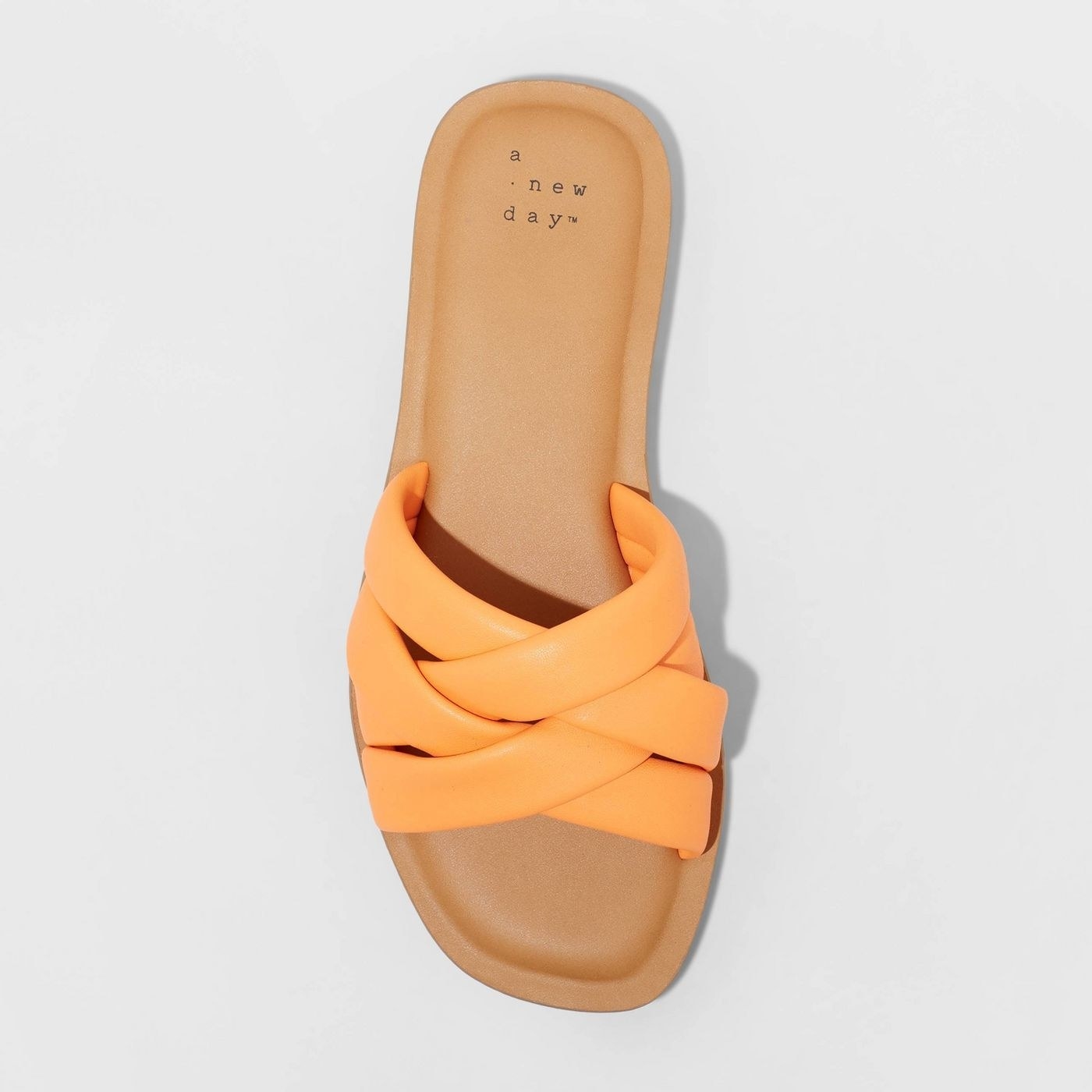 An orange padded slide sandal