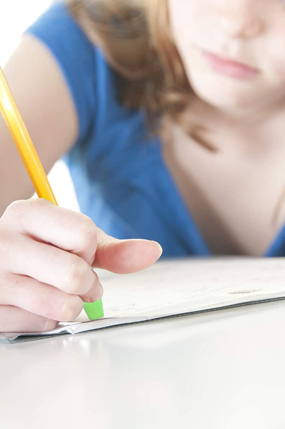 A girl using one of the pencil top erasers