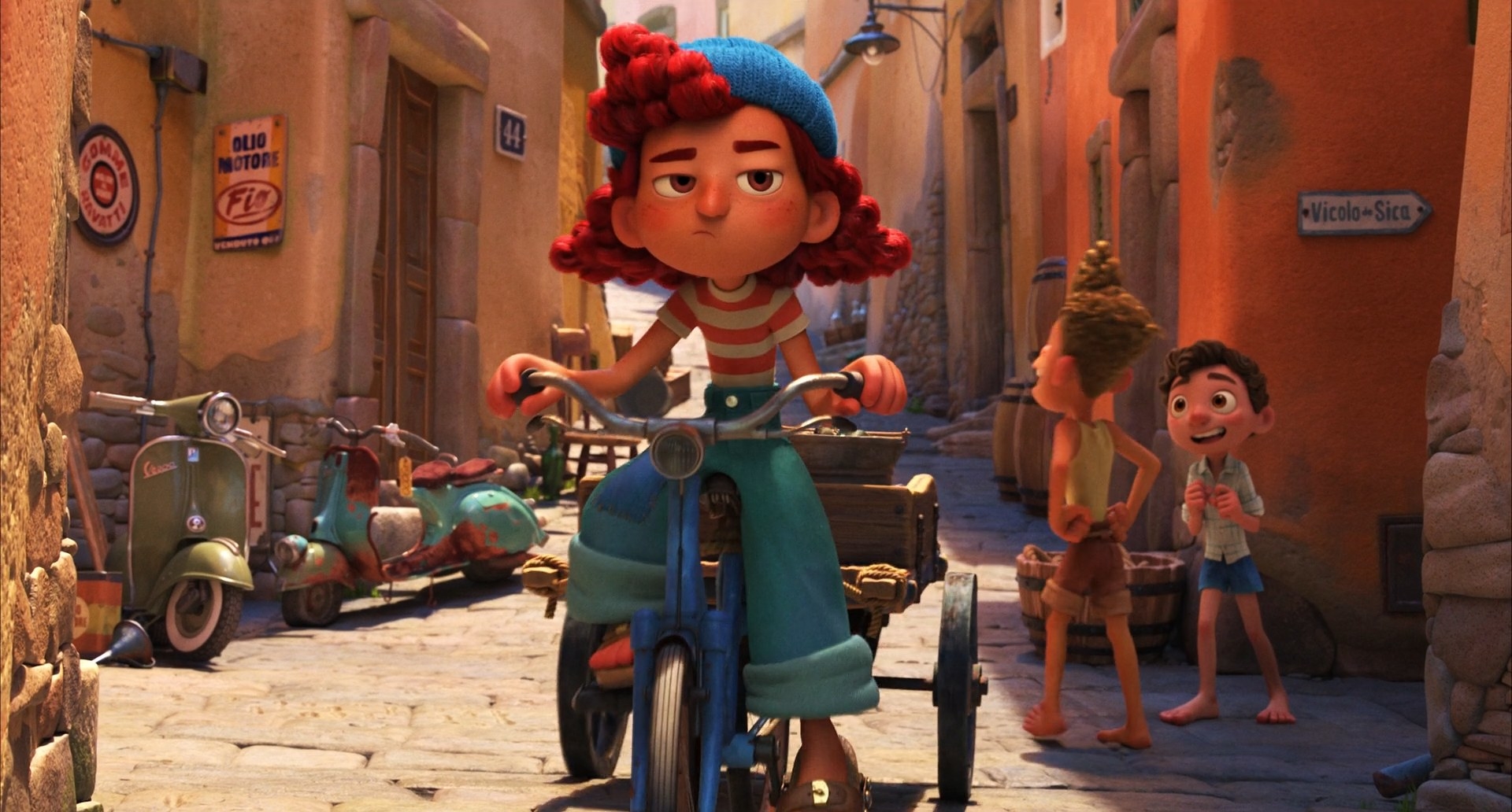 A redhaired girl rides her bicycle pulling a cart attached to the bike while two boys talk in the background