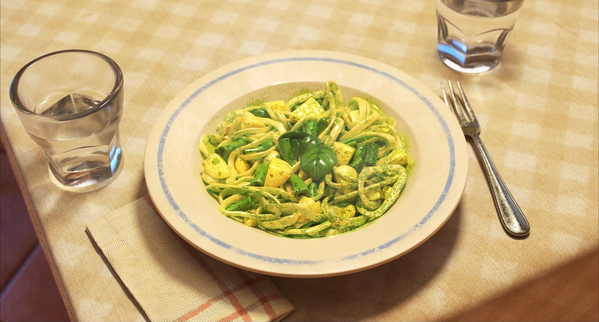 A yellow pasta dish with basil sprinkled on it in a white plate with two glasses of water