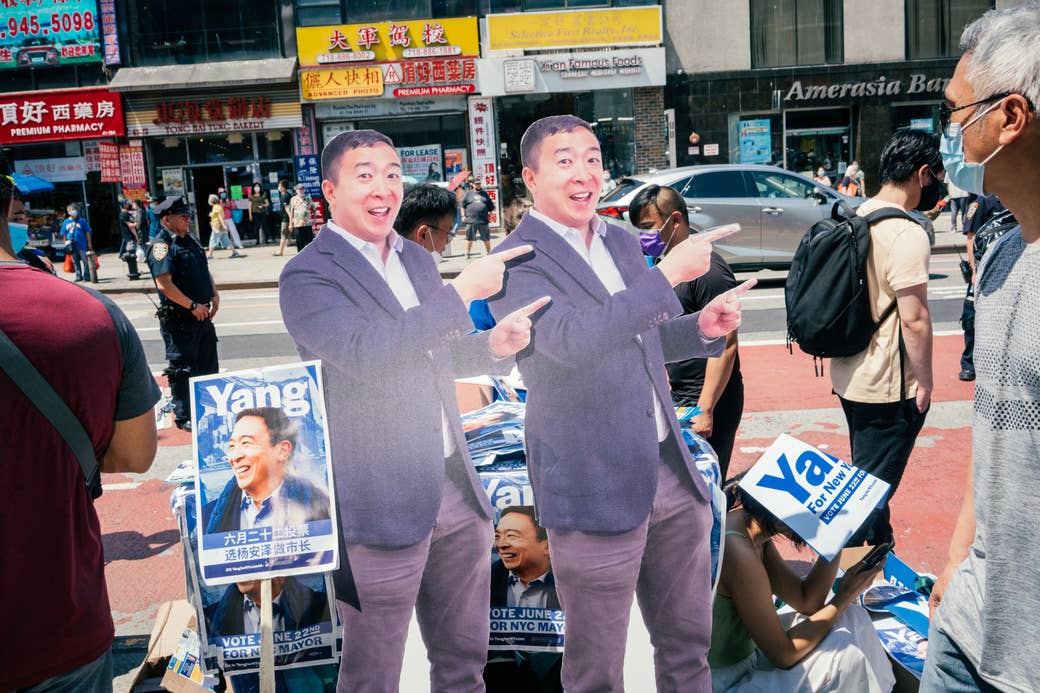 Two life-sized cardboard cutouts pointing with both hands and smiling