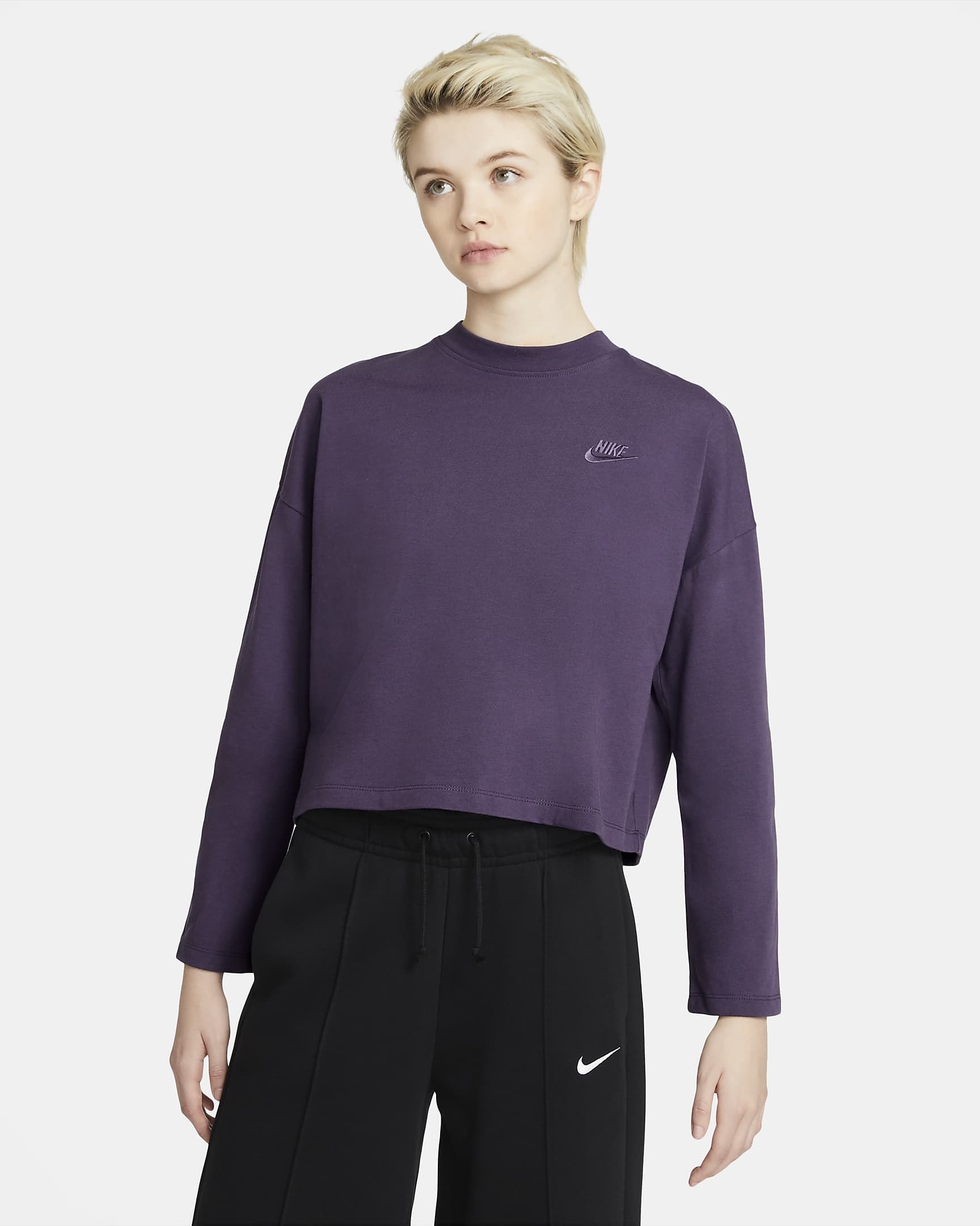 model wearing purple nike crop top