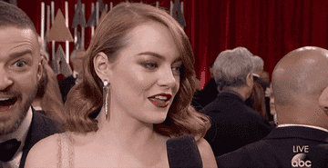 Emma Stone gets interviewed on the red carpet of The Academy Awards
