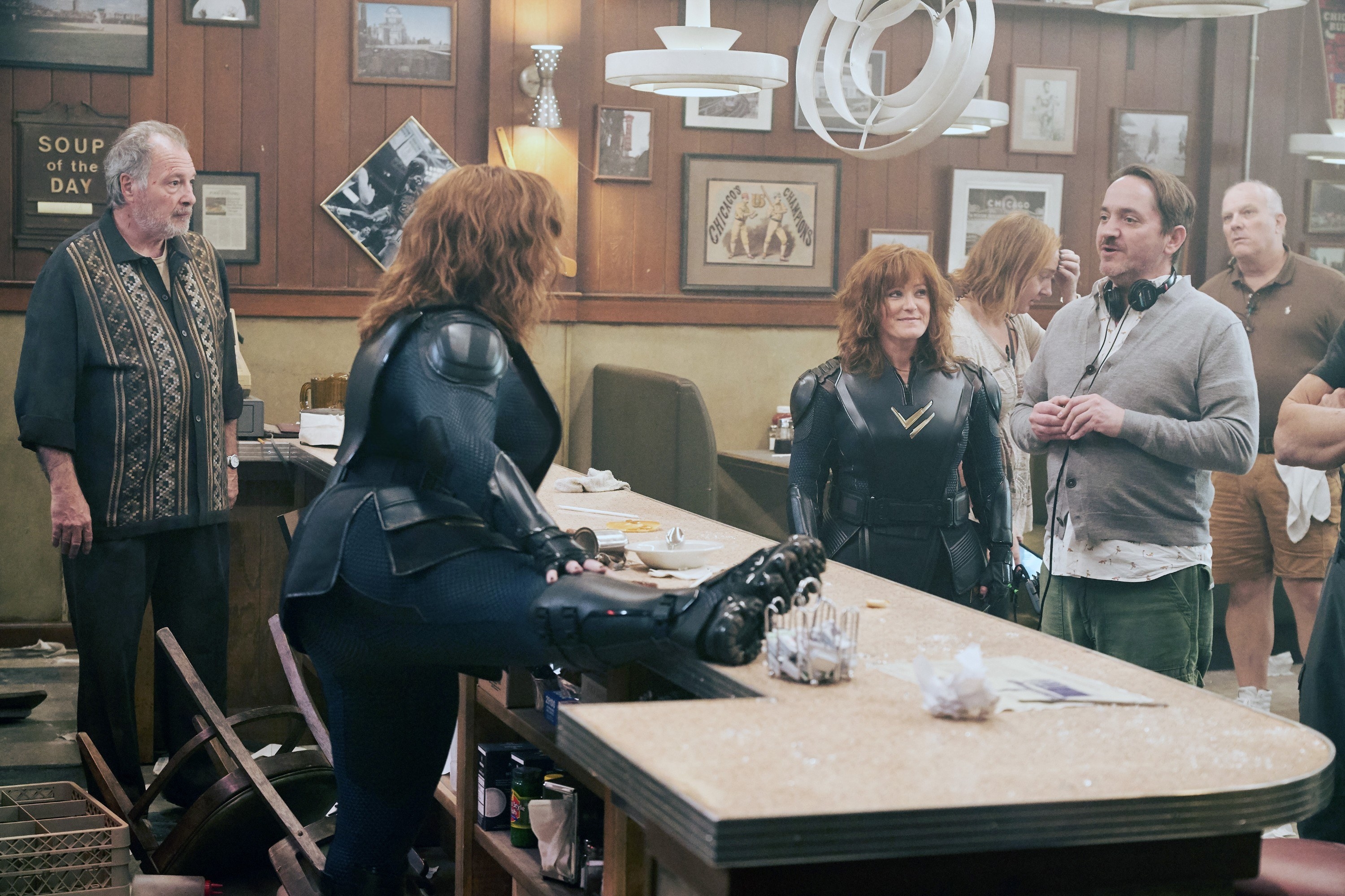 Melissa McCarthy and her stunt double receiving direction from the director of the film