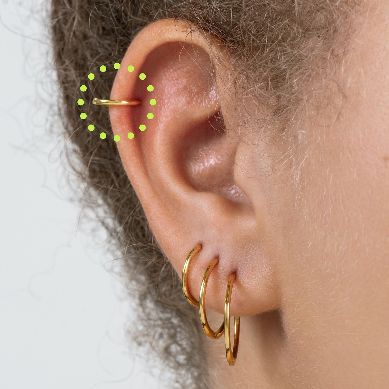 the slim gold hoop on the model&#x27;s cartilage