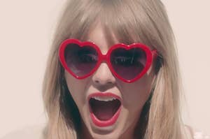 Taylor Swift wearing heart-shaped sunglasses in the "22" music video