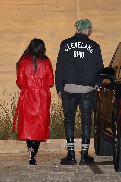 She has a long, bold, red cloak, and he has a Cleveland jacket