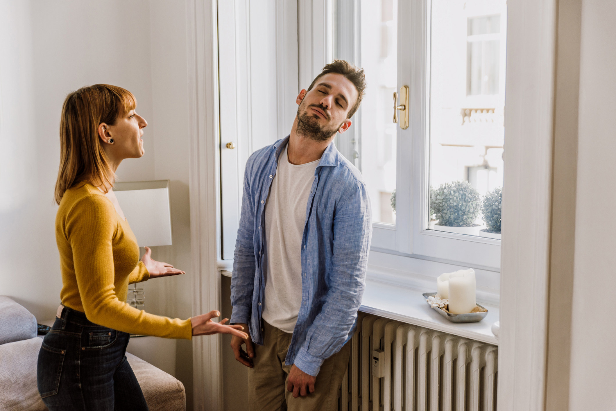 A woman arguing with a man who appears not to be listening