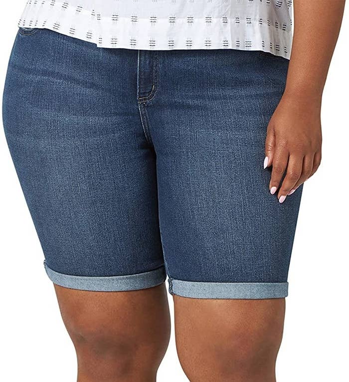 a person wearing denim bermuda shorts