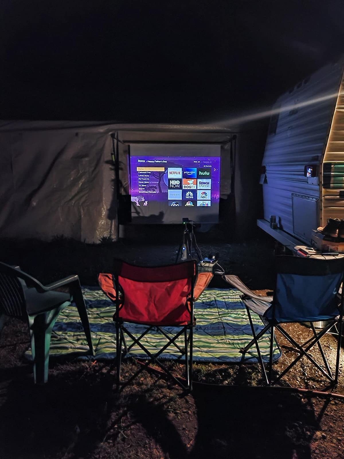 reviewer image of the roku home screen projected onto an outdoor screen using the AKASO mini projector