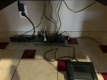 reviewer before image showing a bunch of wires and cords plugged into a power strip