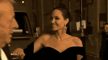 Angelina Jolie waves and smiles at the BAFTAS