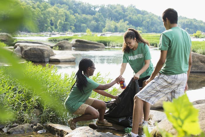 A group of volunteers participating in a river clean up.
