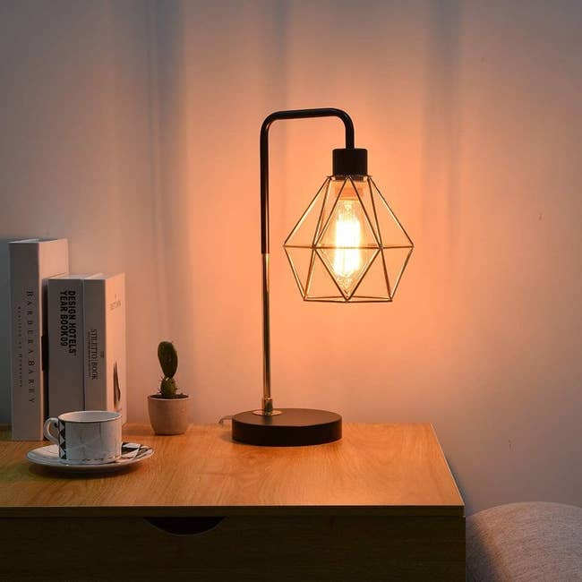 the lamp sits on the wooden side table