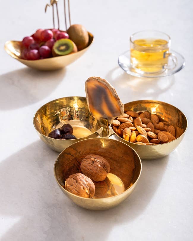 the gold bowl trio with nuts and fruit in each bowl