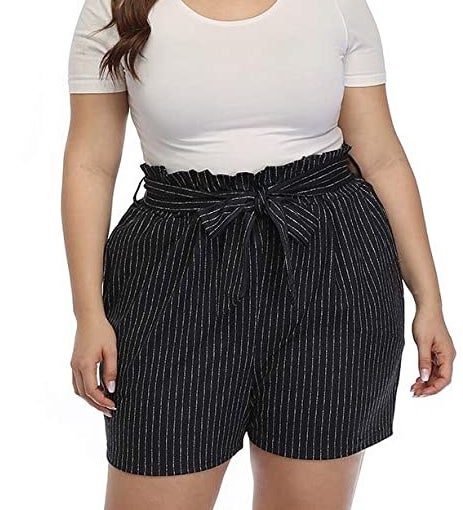 a person wearing pinstripe paperbag shorts