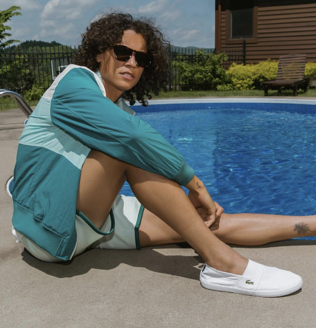 person sitting by the pool wearing the shoes