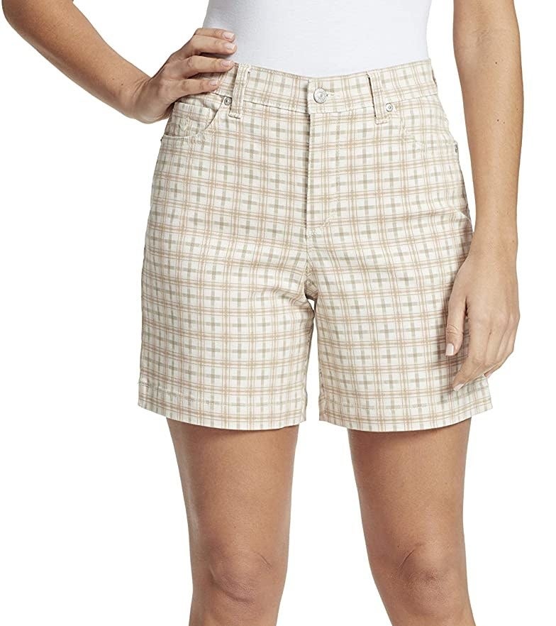 a person wearing a lightly patterned pair of shorts