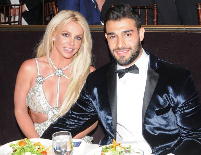 Britney and Sam sit at a table together at an event