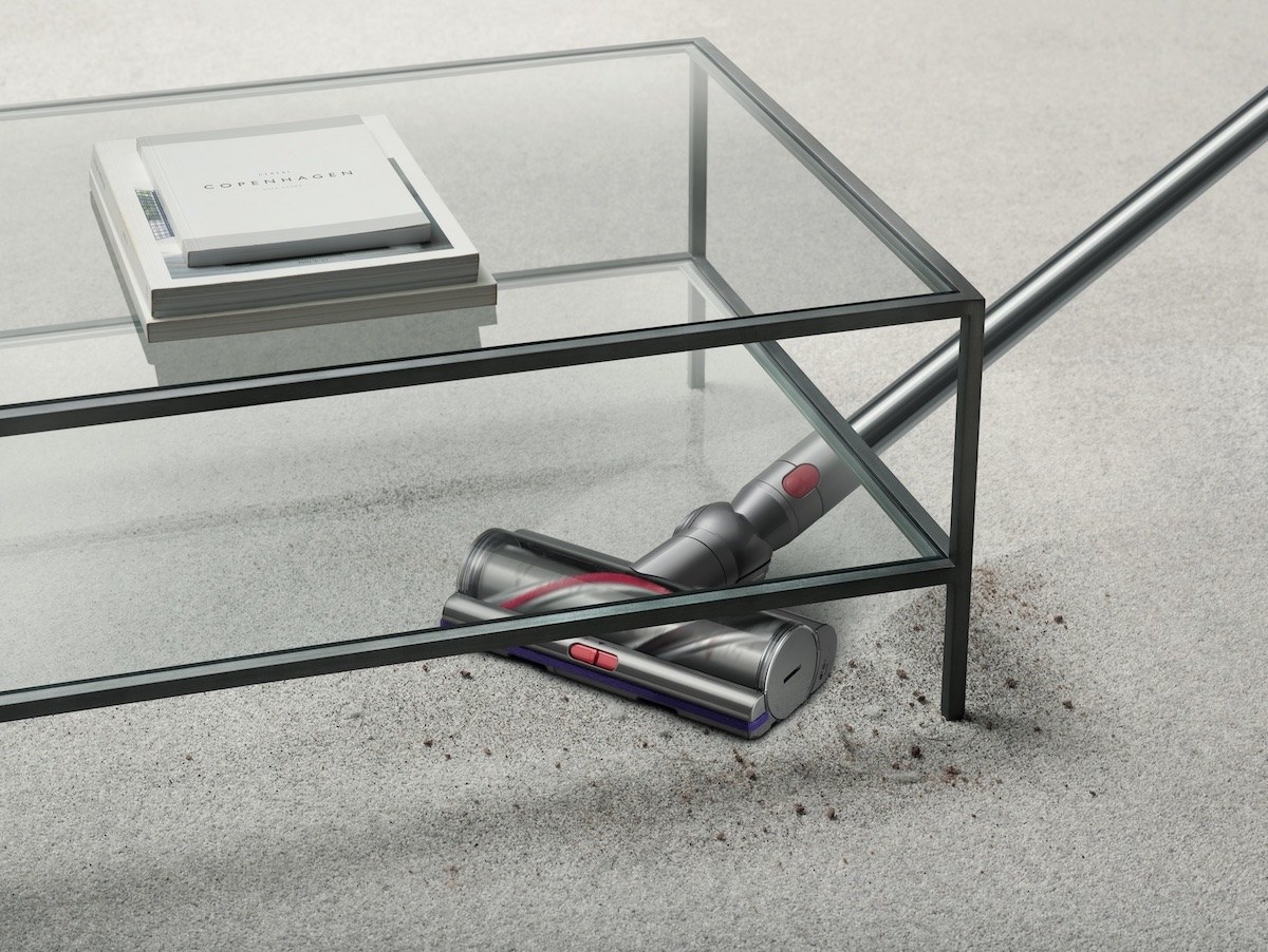 the vacuum cleaning dirt under a glass coffee table